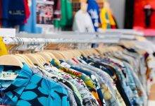 colorful shirts on clothing racks indoors