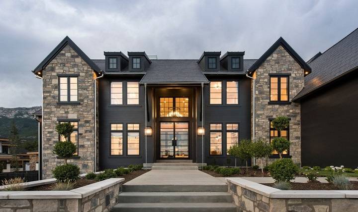 andersen a series windows on a symmetrical home with modern grids charcoal siding and stone
